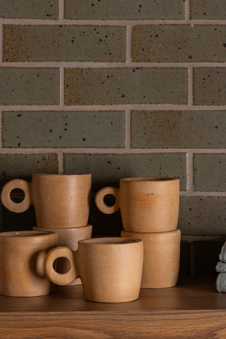 women female artisans handcrafted clay pieces. locally sourced organic materials and sustainable practices