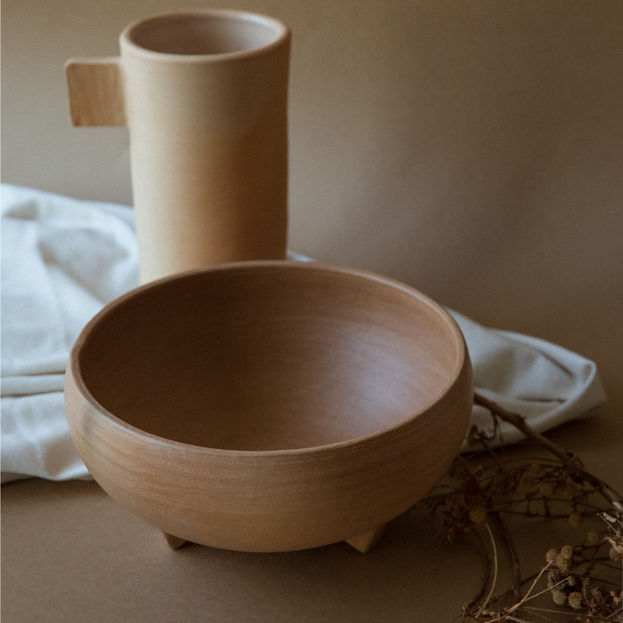 handmade natural terracota barro serving bowl staged with pitcher and decorative branches