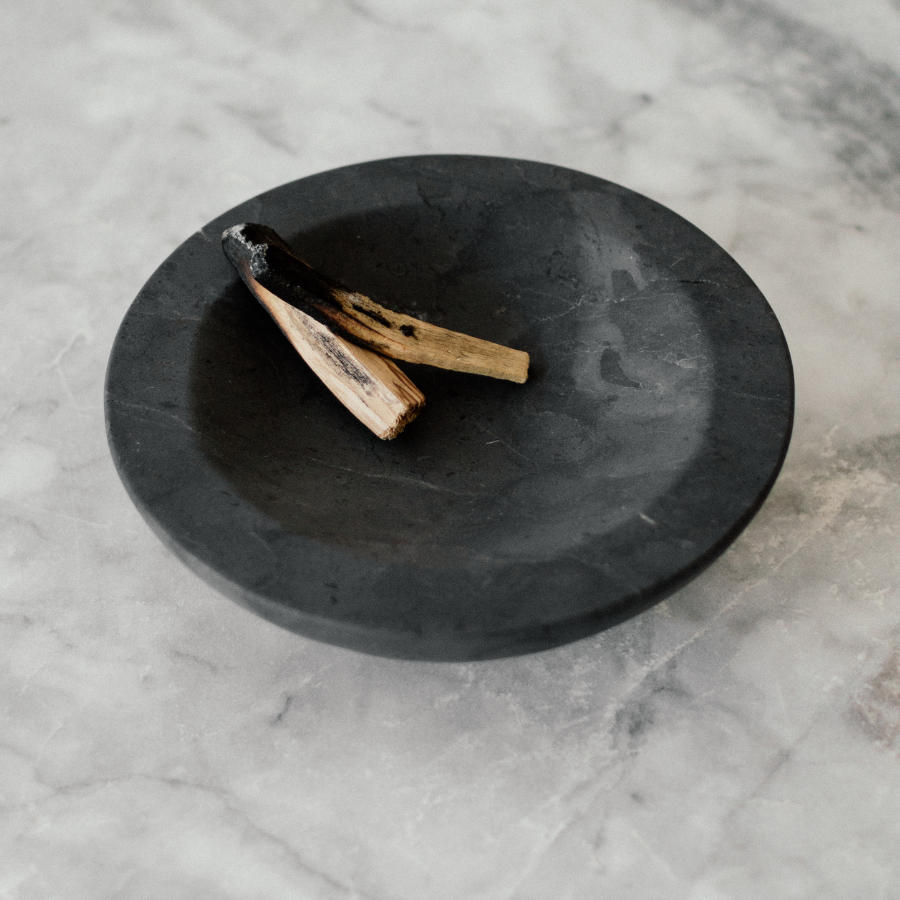 black marble small dish with palo santo inside
